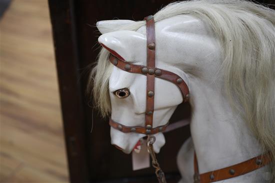 A dapple grey painted carved wood rocking horse, length 40in.